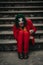 Cosplayer in the image of a crazy clown sits handcuffed and laughs