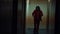 Cosplayer in the image of a crazy clown from the thriller `Joker` walks and dances in corridor.
