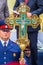 A Cossack officer holds a sacred large cross in his hands