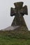 Cossack`s grave on the hill. Old stone cross. Green grass