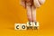 Cost control symbol. Businessman turns wooden cubes and changes the concept word Cost to Control. Beautiful orange table orange