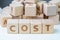 Cost, expense or company profit and loss concept, cube wooden bl