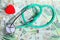 Cost of health care: stethoscope red heart polish money