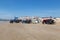 Costa da Caparica, Portugal - September 10, 2020: An artel of fishermen trawls fish from the tourist beach using a tractors.