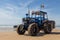 Costa da Caparica, Portugal - September 10, 2020: An artel of fishermen trawls fish from the tourist beach using a tractors.