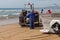 Costa da Caparica, Portugal - September 10, 2020: An artel of fishermen trawls fish from the tourist beach using a tractors.