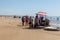 Costa da Caparica, Portugal - September 10, 2020: An artel of fishermen trawls fish from the tourist beach using a tractors.