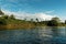 Costa Rica landscape from Boca Tapada, Rio San Carlos. Riverside with meadows and cows, tropical cloudy forest in the background.