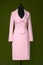 costume female suit rose pink on black tailor mannequin in front of dark green