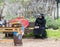 A Costumed Doctor Death sits near a warehouse with armor and shields at the Purim Festival with King Arthur in the city of Jerusal