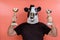 Costumed person with cow mask showing trophies