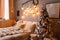 Cosy bedroom with eco decor. Wood and nature concept in interior of room. Scandinavian interior with christmas tree, real photo. H