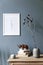 Cosy, boho living room interior with white poster frame on the wall.