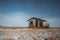 Cosy log cabin retreat in snow covered landscape, Iceland, Europe. Iceland nature with typical yellow grass and snow