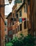 Cosy narrow neighborhood in Europe with laundry hanging from a building