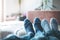 Cosy relaxing in the wintertime at home: Couple with woollen socks is lying on the couch