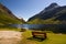 Cosy romantic seating on bench in mountains by lake, Norway