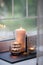 Cosy and soft winter autumn home background, karoma stick and candles on an stone board on windowsill. Christmas or seasonal