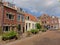 Cosy street with typical Dutch houses with potted plants in a street in Utrecht, the NEtherlands