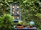 Cosy, welcoming corner of garden with cacti, plant pots and blue table