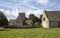 Cotswold church and Tithe Barn at Guiting Power, Gloucestershire, England