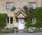 Cotswold cottage facade with flower border