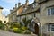Cotswold stone houses line the streets in Painswick, Gloucestershire, UK