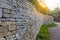 Cotswolds stone fence shown in leading perspective with sun flare