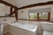 Cottage bathroom with exposed beams and mosaic tiles