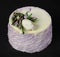 Cottage cheese cake decorated with white chocolate flowers on a dark background. Selective focus
