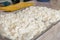 Cottage cheese is on display at the farmers ` market. A farmer prepared cottage cheese for sale at the dairy market. Close up