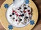 Cottage cheese with fresh blueberries and lingonberries in a bowl for healthy breakfast
