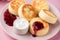 Cottage cheese fritters Syrniki with raspberry jam and sour cream