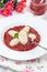 Cottage cheese gnocchi with strawberry sauce on a fork vertical