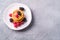 Cottage cheese pancakes, curd fritters dessert with raspberry and blackberry berries in plate on stone concrete background