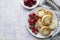 Cottage cheese pancakes, ricotta fritters on ceramic plate with  fresh strawberry