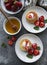 Cottage cheese pancakes, ricotta fritters on ceramic plate with  fresh strawberry