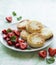 Cottage cheese pancakes, ricotta fritters on ceramic plate with  fresh strawberry