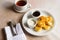 Cottage cheese pancakes, syrniki, ricotta fritters on white ceramic plate with sour cream and jam. Healthy and delicious morning