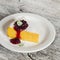 Cottage cheese and pumpkin casserole with berry sauce on a white plate