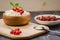 cottage cheese with red currant in a wooden plate/cottage cheese with red currant in a wooden plate on a dark backgraund.