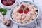 Cottage cheese topped with raspberries in a bowl