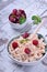 Cottage cheese topped with raspberries on white table