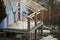 Cottage house building under construction with walls made of hollow foam insulation blocks, wooden roof frame and attached porch