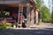 Cottage house construction in mountain forest. Building, ladder and some equipment, summer day. Ukrainian Carpathians resort