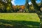 A cottage overlooking a meadow with autumn colors