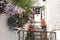 Cottage with potted plants and hanging baskets in Polperro in the summer.