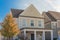 Cottage style house with covered patio and wood siding with ceiling fans near Dallas