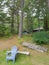 Cottage in the trees with dock and chair