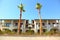 Cottages with balcony and garden with palm trees